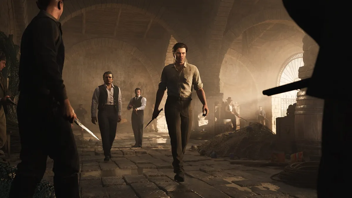 A man walks toward knife-wielding enemies in a dim stone hall in Mafia: The Old Country