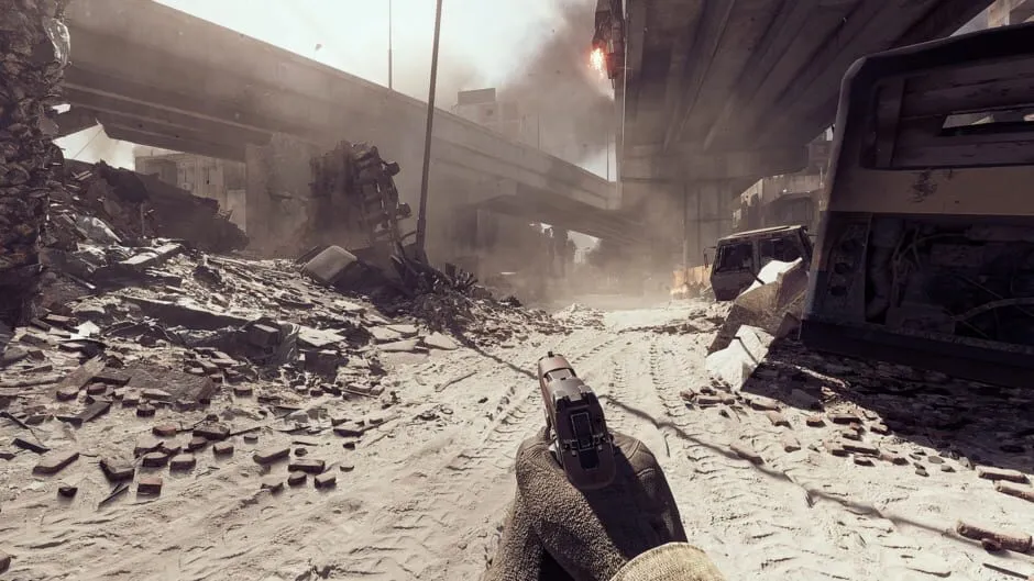 A first-person view of a pistol on a dusty road beneath a highway overpass, with debris and wrecked vehicles around